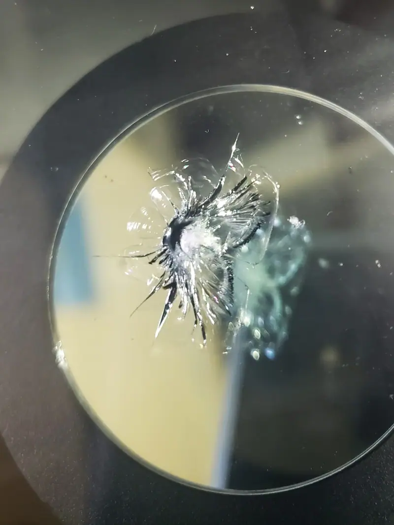 Close-up view of a combination break with star-like cracking pattern.